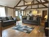 Stunning lounge area with plenty of space for everyone. Comfortable new sofas.  Central Woodburner,  large window looking out onto courtyard garden.  Vaulted ceiling and original beams. 50 inch wall mounted flat screen smart t.v.